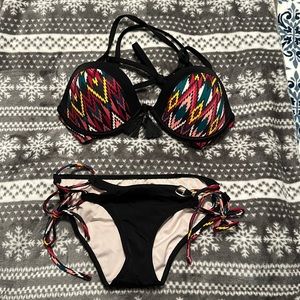 Black bikini with a cool design! Never warn! Top is 36B and bottoms are XS